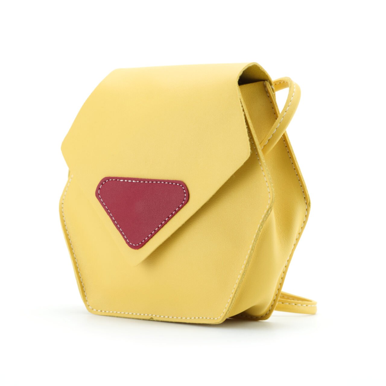 Yellow crossbody bag with red front detail — product photography on white background